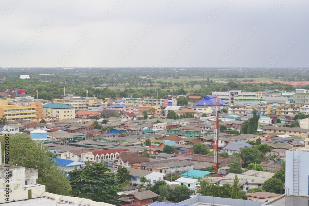 City scenery in Thailand Dense community with fields, looking from high angles, sky, rain.
