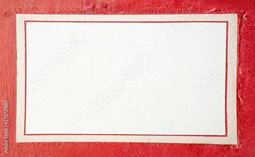 white wall with red frame of an old half timbered house as space for messages photo