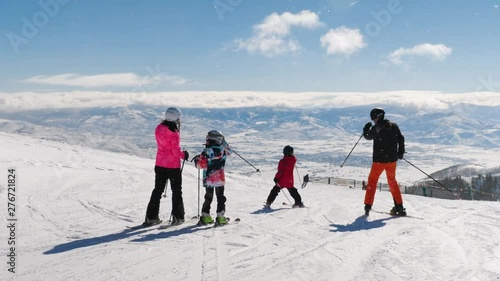 Picturesque View Of Happy Family Riding Ski And Heber Valley Mountains. Excellent beautiful shot of happy family looking to Heber Valley mountains in Utah.