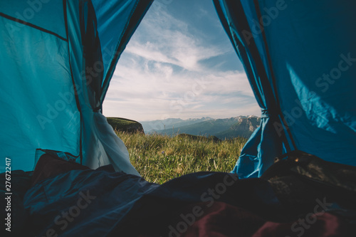 view from the window of a tent on the mountain expanses on a sunny summer morning
