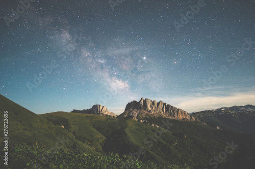 mountain range against the night starry sky and the milky way