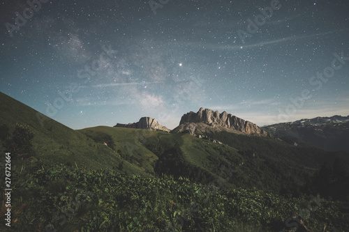 mountain range against the night starry sky and the milky way