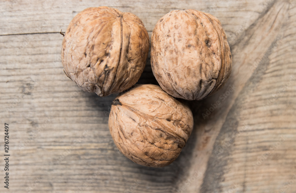 walnuts on a gray wooden board walnuts on a gray wooden board
