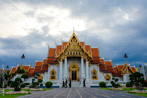 Bangkok, Thailand - June 14, 2019: Peopel visit Benjamaborpit Temple. This temple known as the marble temple, it is one of Bangkok's most beautiful temples. © thebigland45