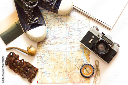 Young traveler planning a vacation. Travel accessories, passports, baggage, map, prepared for the trip. Suitcase travel preparation concept