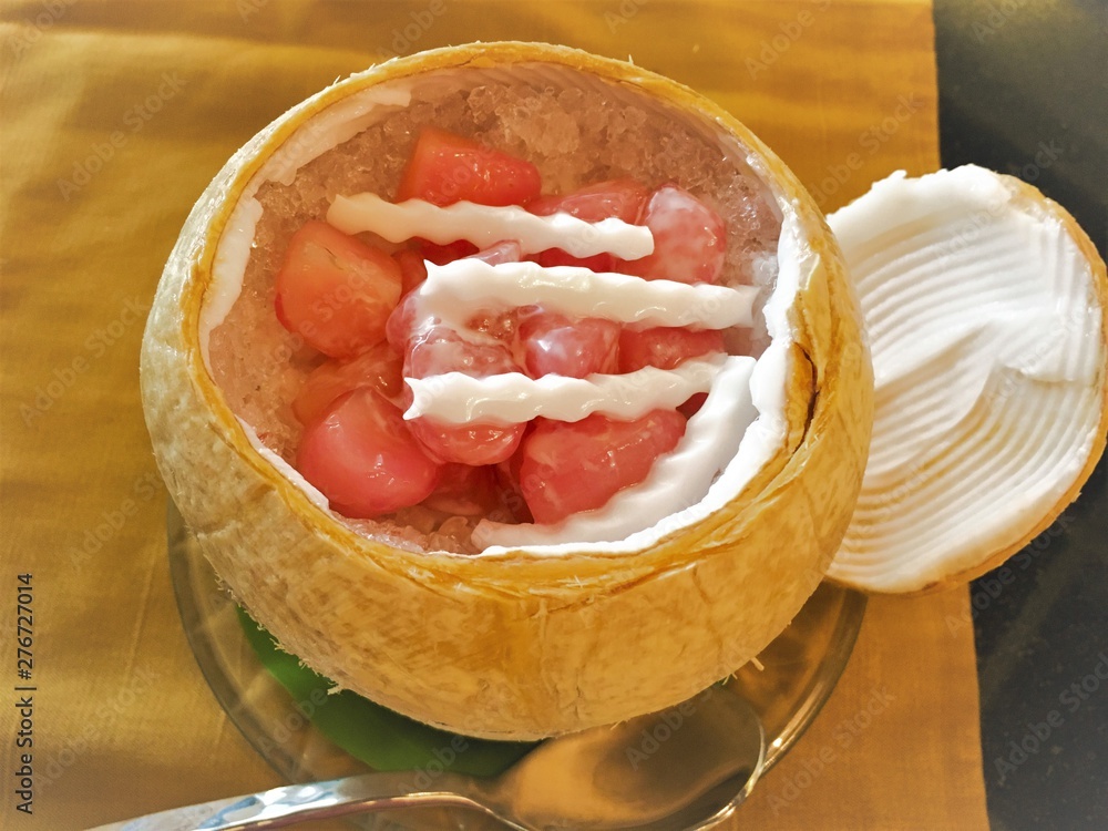 Water Chestnuts in Coconut Milk(Thapthim krop) in coconut Milk and syrup on coconut shell.mock