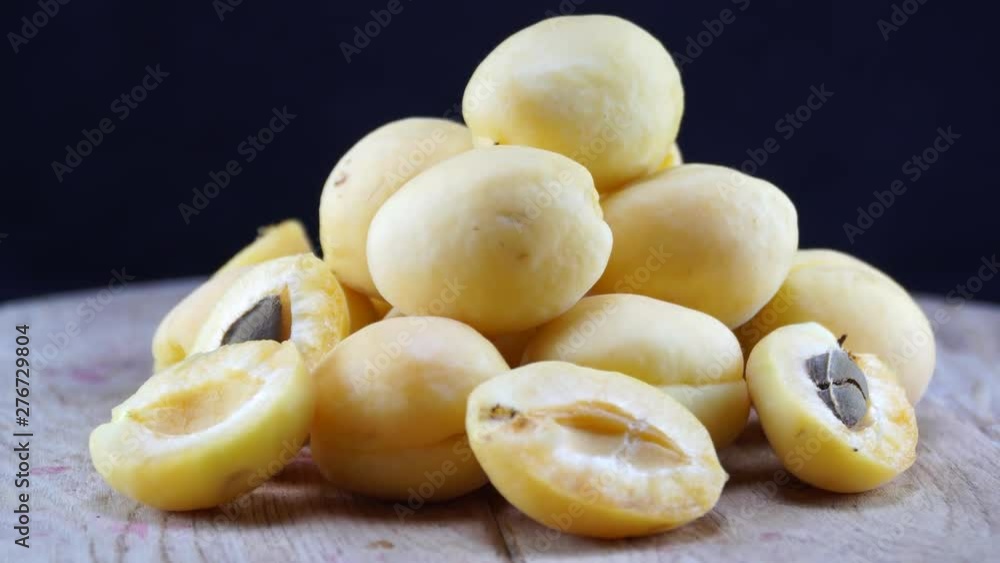 White apricots rotating on wooden table. 4K White apricots rotating on wooden table. 4K