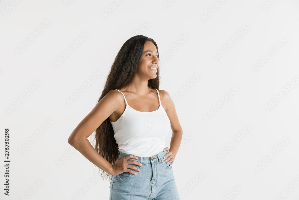 Beautiful female half-length portrait isolated on white studio background. Young emotional african-american woman with long hair. Facial expression, human emotions concept. Standing and smiling. Beautiful female half-length portrait isolated on white studio background. Young emotional african-american woman with long hair. Facial expression, human emotions concept. Standing and smiling.