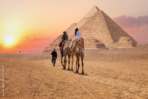 Tourists on camels near the Great Pyramids of Giza, Egypt