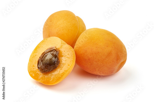 Fresh apricot fruits with juicy half, ripe nectarines, close-up, isolated on white background