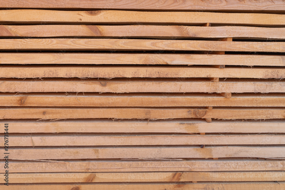 Fototapeta premium Construction boards, strap, folded into a neat pack on a construction site. Creative vintage background.