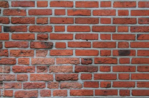 Brick wall of red color texture background
