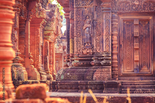 Celestial maiden carved into the red sandstone walls, Banteay Srei temple, Angkor, Cambodia.