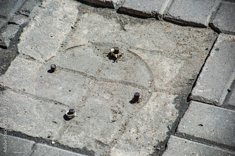 Fototapeta premium Reinforcement from the place of fastening of pillar in pavement