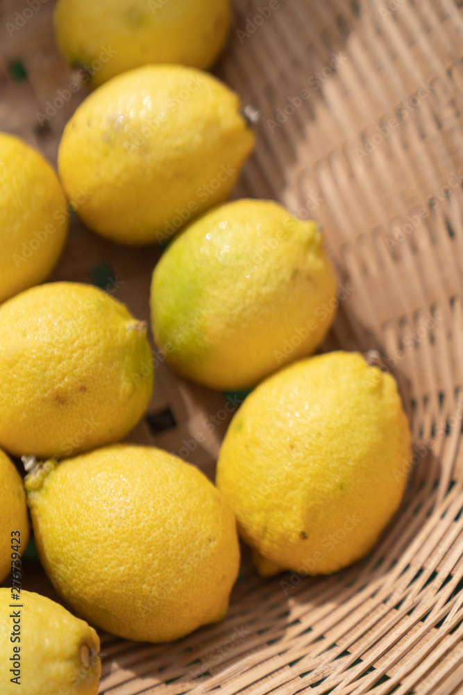 Composition of lemons setting in basket in natural light scene / food material / food background / raw material / food photography