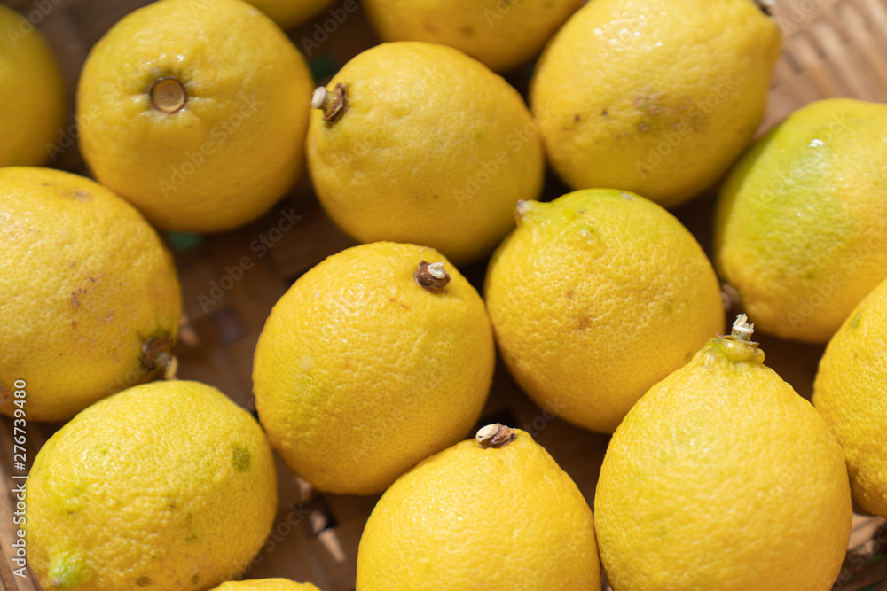 Close up lemon setting in basket in natural light scene / food material / food background / raw material / food photography Close up lemon setting in basket in natural light scene / food material / food background / raw material / food photography