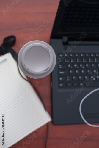 Wood office desk table with laptop, cup of coffee