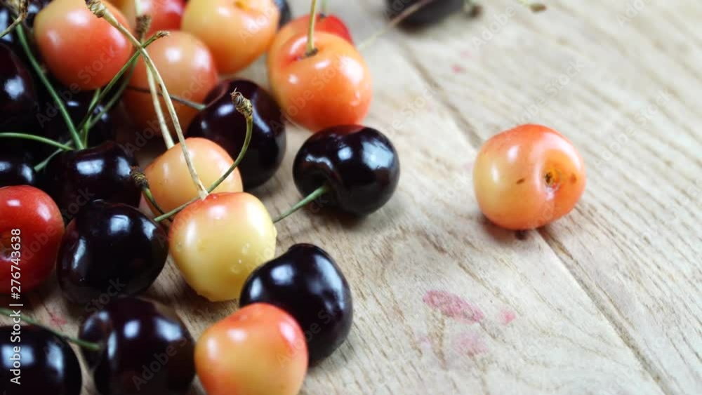 Delicious cherry varieties on wooden table. 4K Delicious cherry varieties on wooden table. 4K