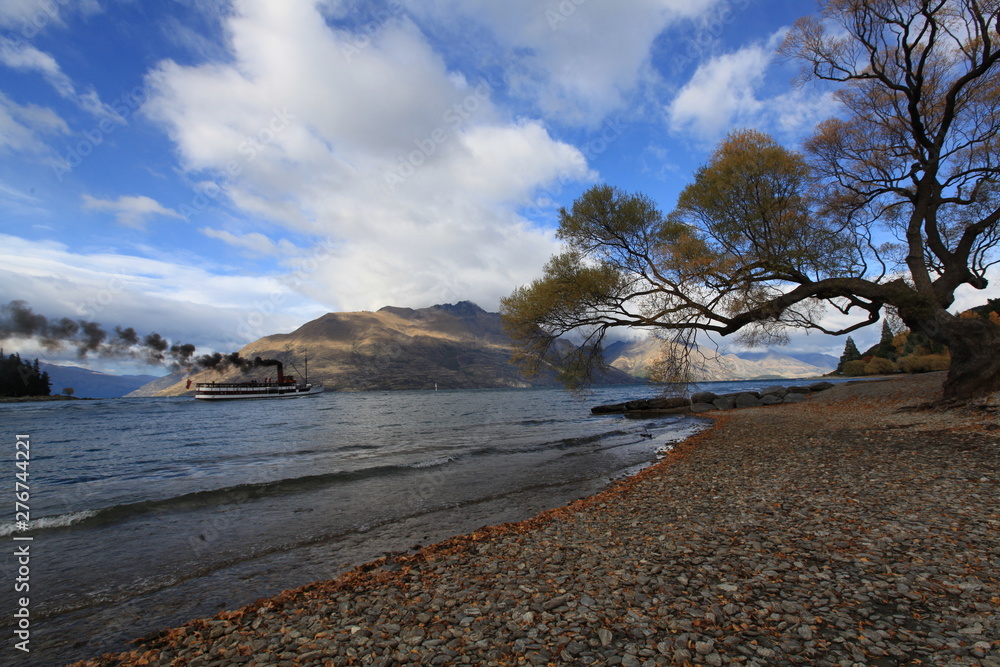 wonderful lake view in fall season with mountain and steamboat background wonderful lake view in fall season with mountain and steamboat background