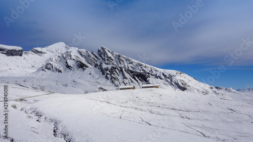 Traditional wooden houses on the mountainside in Grindelwald, Switzerland.