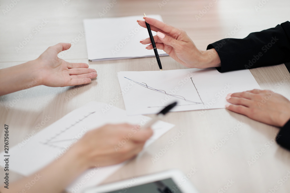 Close-up desktop. Tablet, charts and documents. The concept of team office work. Women at work. Close-up desktop. Tablet, charts and documents. The concept of team office work. Women at work.