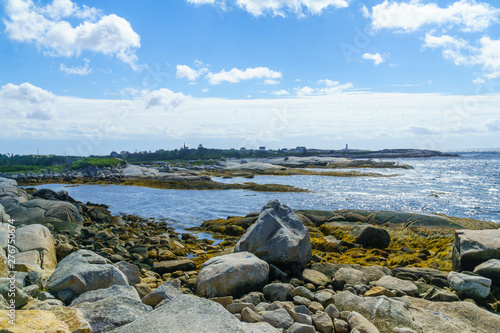 Rocky shore with Peggys Cove in the background
