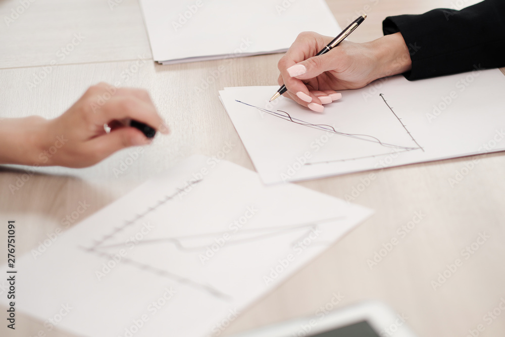 Close-up desktop. Tablet, charts and documents. The concept of team office work. Women at work. Close-up desktop. Tablet, charts and documents. The concept of team office work. Women at work.