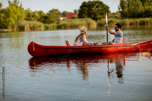 Loving couple rowing on the...