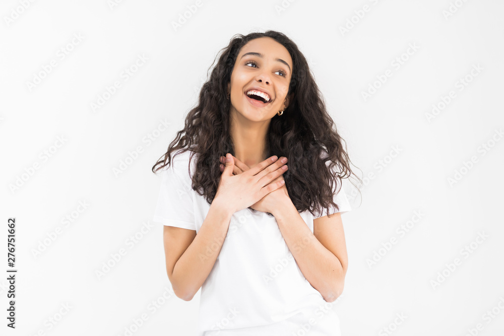 Pleased woman reclines on her hands and looking at the camera over white background Pleased woman reclines on her hands and looking at the camera over white background