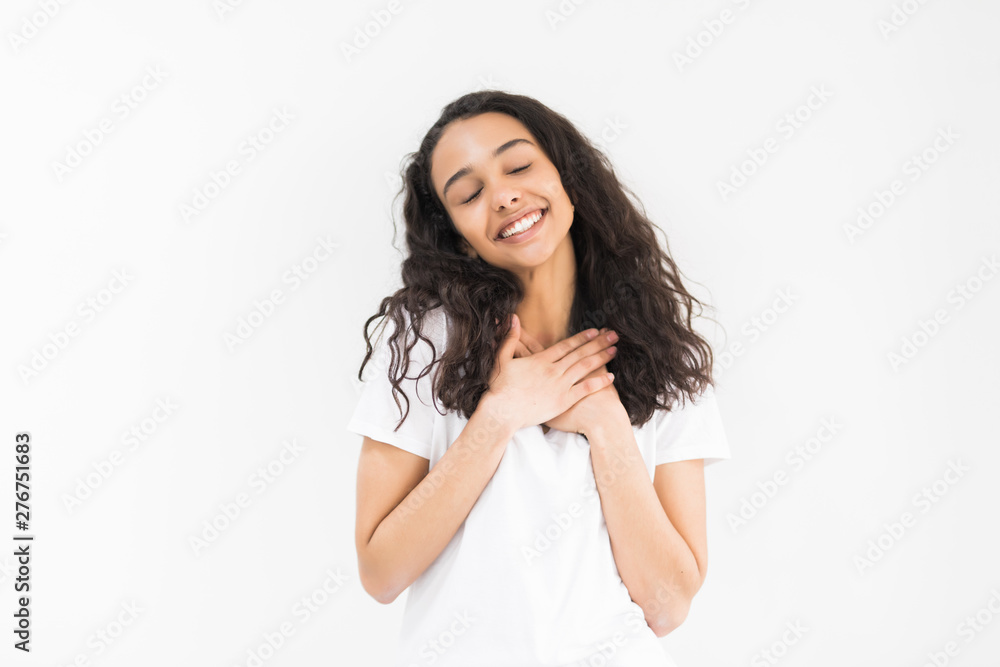 Pleased woman reclines on her hands and looking at the camera over white background Pleased woman reclines on her hands and looking at the camera over white background