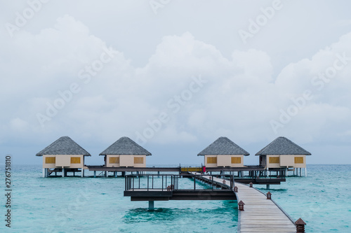 Fototapeta Naklejka Na Ścianę i Meble -  Water Villas and wooden bridge at Tropical beach in the Maldives