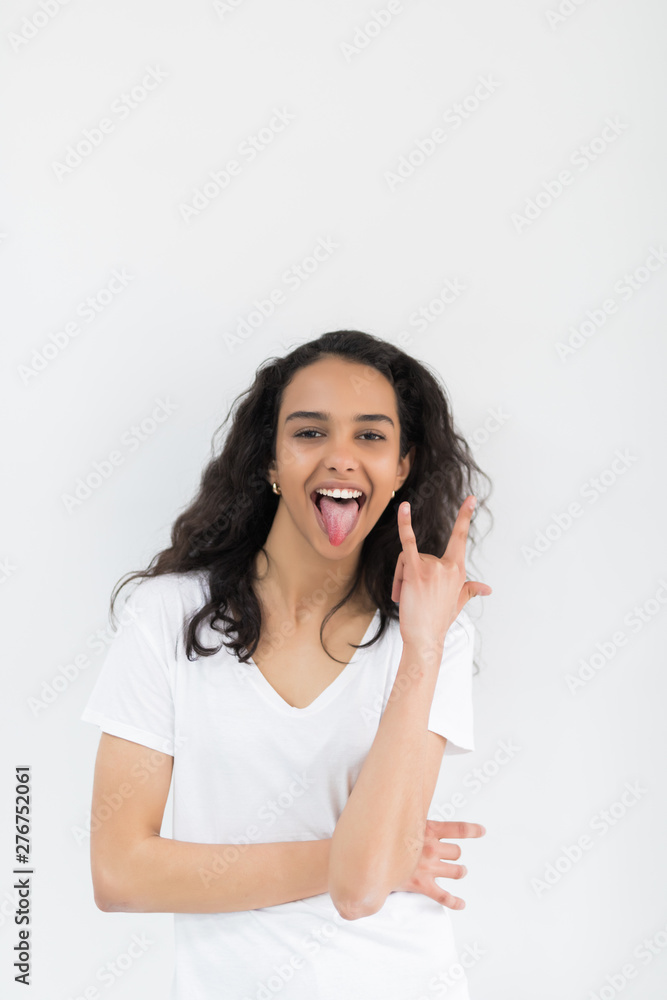 Young pretty woman with rock sign isolated on white background Young pretty woman with rock sign isolated on white background