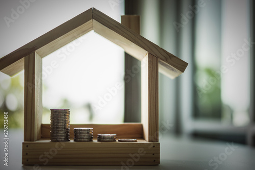 House model and row of coin money on white table, Real Estate market, Trading Estate, Mortgage Concepts