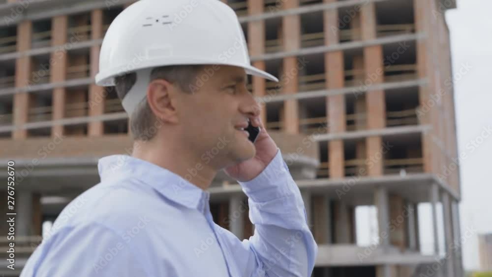 Engineer with white helmet calling by phone. 4 K Engineer with white helmet calling by phone. 4 K