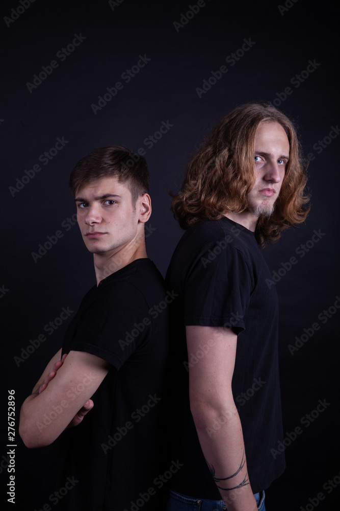 Rock band consisting of two young caucasian adults posing in the studio Rock band consisting of two young caucasian adults posing in the studio