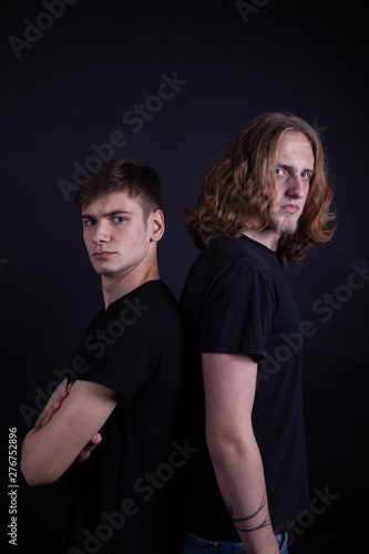 Rock band consisting of two young caucasian adults posing in the studio