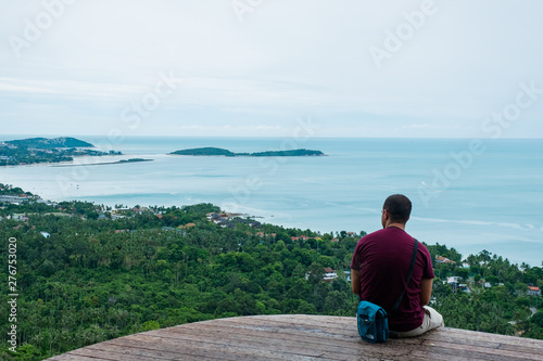 Surat Thai, Thailand - June 25, 2017: A man sit on top of the mountain looking out from the viewpoint at Koh Samui.