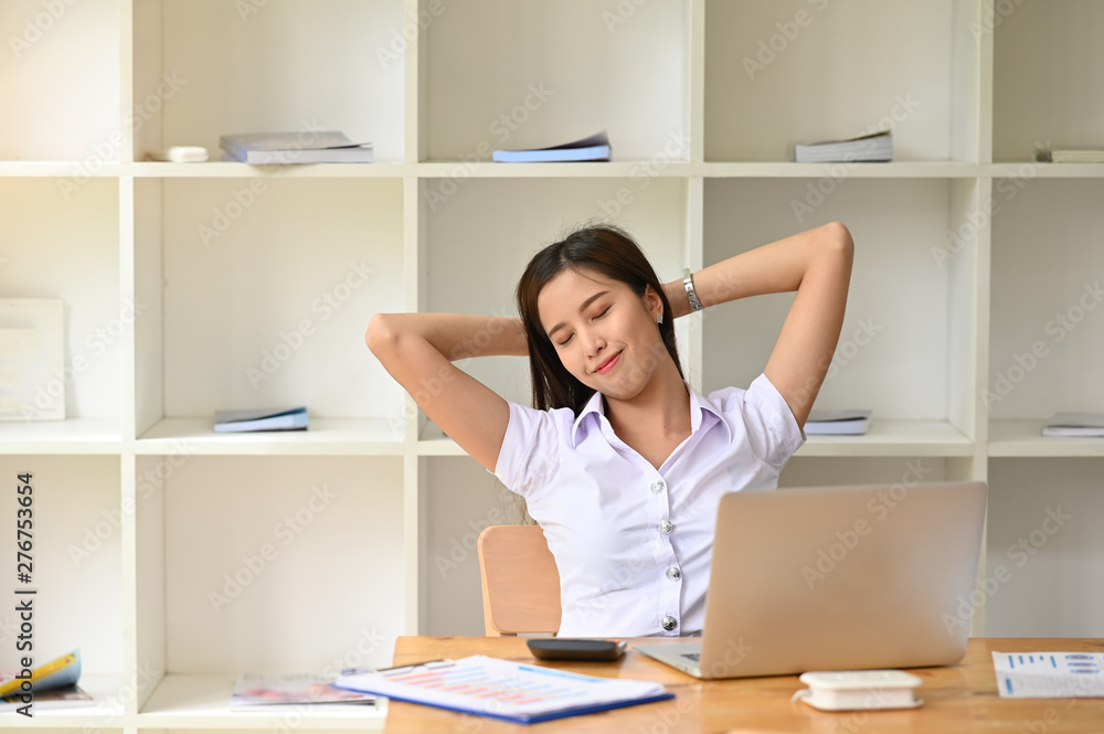 Relaxing at comfortable in office woman hands behind head, happy woman resting in office satisfied after work. Relaxing at comfortable in office woman hands behind head, happy woman resting in office satisfied after work.
