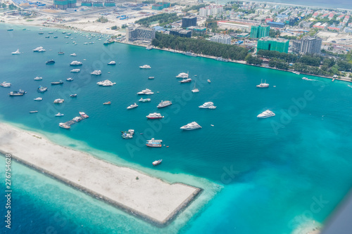 Scenery above the blue ocean from airplane window Maldives island © wassamon