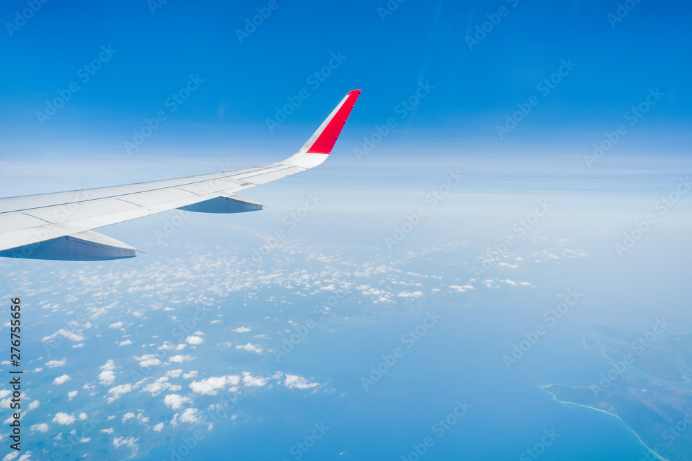 Fototapeta premium aircraft Wing on cloudscape and blue sky