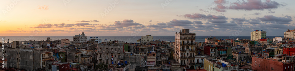 Aerial panoramic view of the residential neighborhood in the Old Havana City, Capital of Cuba, during a colorful cloudy sunset.