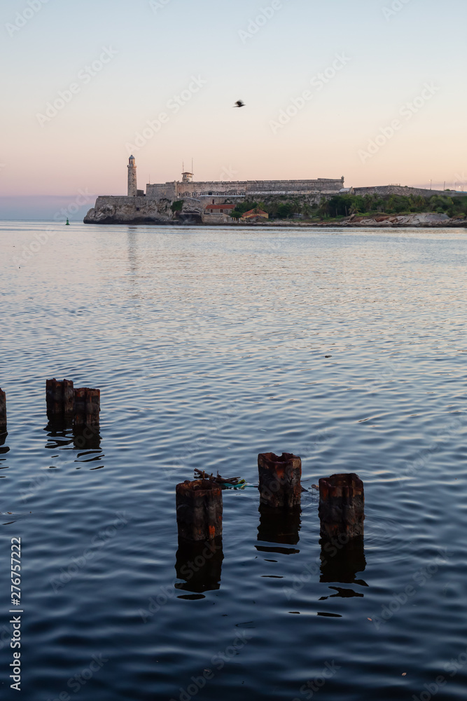 Fototapeta premium Beautiful view of the Lighthouse in the Old Havana City, Capital of Cuba, during a colorful and sunny sunrise.
