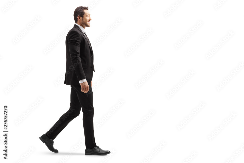 Young man in a suit walking and smiling Young man in a suit walking and smiling