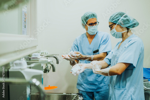 Unrecognizable doctor washing hands before operating photo