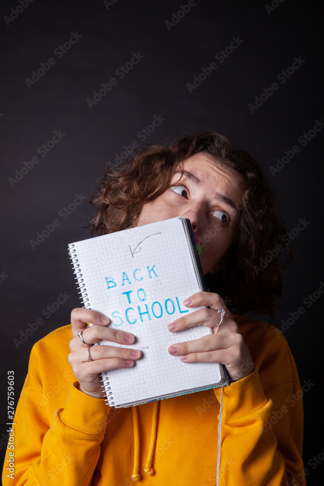 Young caucasian girl holding notebook with Back to School Young caucasian girl holding notebook with Back to School