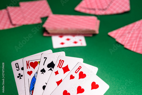 playing cards on a green table in different combinations close-up
