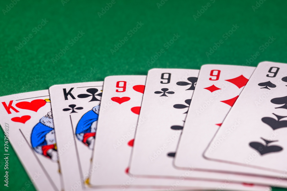 playing cards on a green table in different combinations close-up