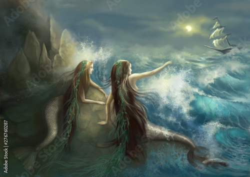 Fototapeta Hunting two mermaids in the rocks on the background of a stormy ocean and the raging waves