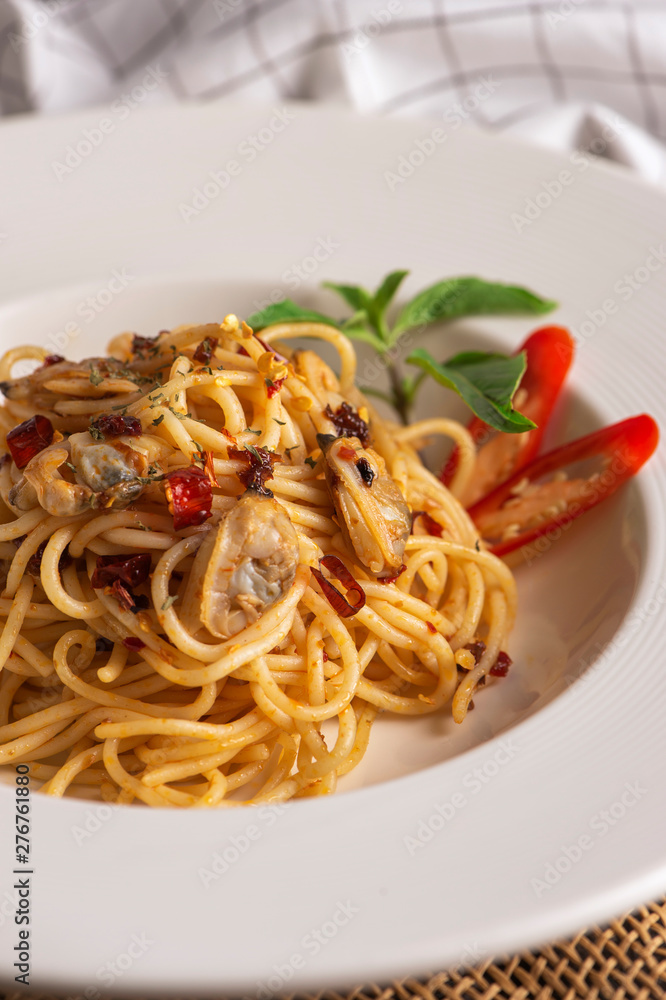 Spaghetti with shellfish served in a white dish Spaghetti with shellfish served in a white dish