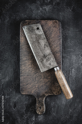 Rustic Cutting Board and Meat Cleaver on Dark Background